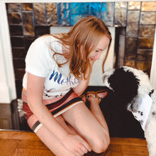 Load image into Gallery viewer, woman sitting down on floor looking at black and white doodle wearing matching white tee and bandana inspired by game of thrones
