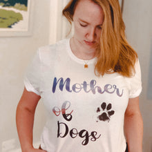 Load image into Gallery viewer, woman looking down at white tee which reads &quot;Mother of dogs&quot; inspired by game of thrones
