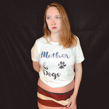 Load image into Gallery viewer, woman standing looking in the distance wearing a white tshirt which reads &quot;Mother of dogs&quot; inspired by game of thrones
